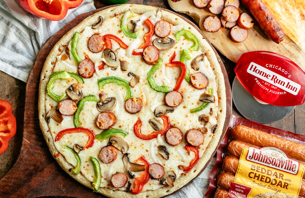 Pizza topped with Johnsonville Sausage, bell peppers