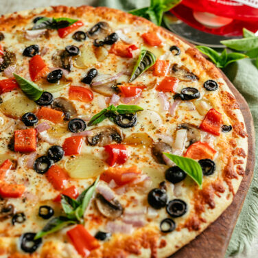 Baked Pizza Topped with a medley of vegetables
