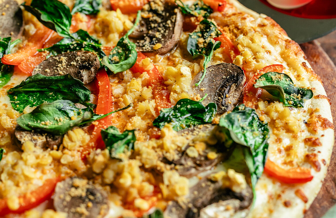Baked pizza topped with lentils and veggies