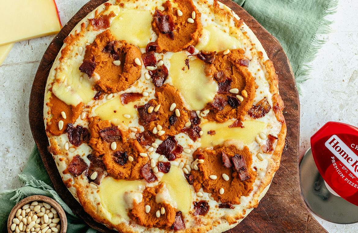 Baked pizza topped with gouda, pumpkin, and more