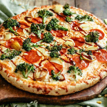 Baked Pepperoni Pizza topped with Broccolini, garlic, and soy glaze
