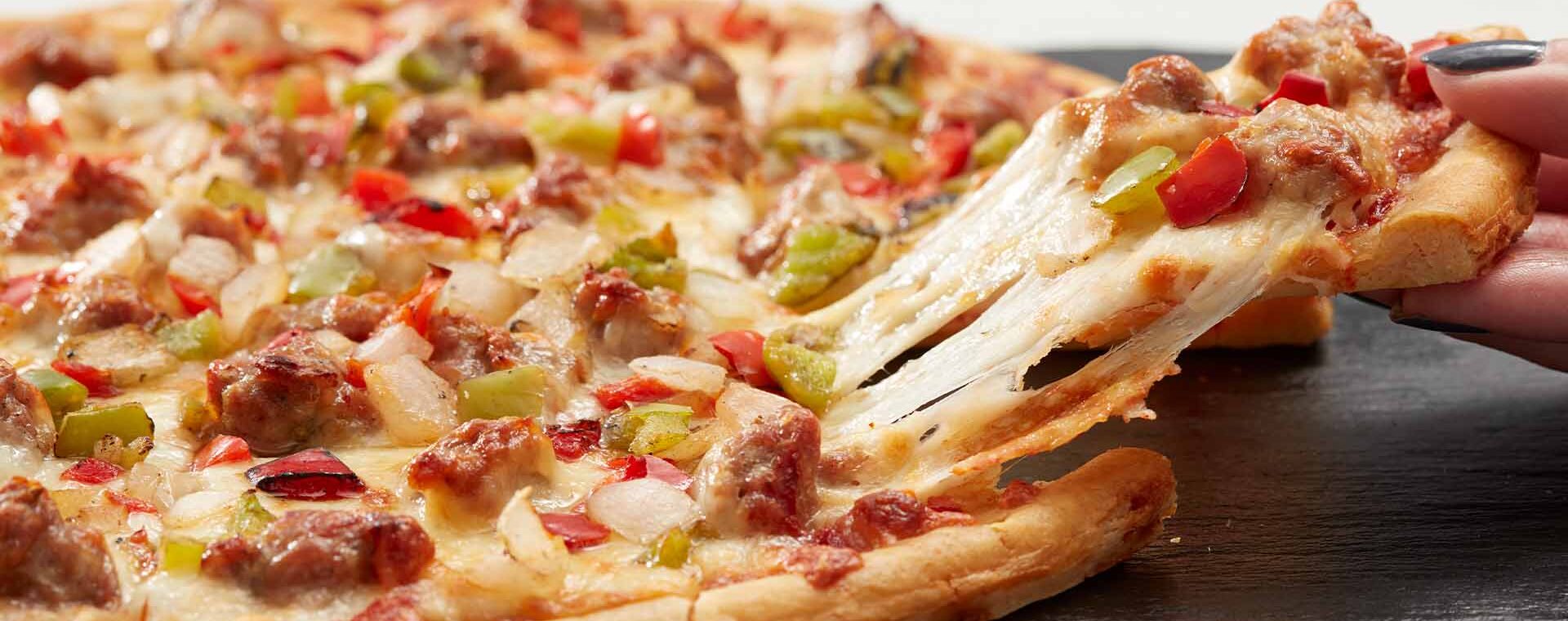 Home Run Inn sausage tavern-style thin crust pizza cut into squares