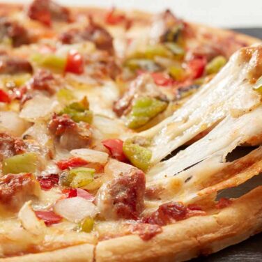 Home Run Inn sausage tavern-style thin crust pizza cut into squares