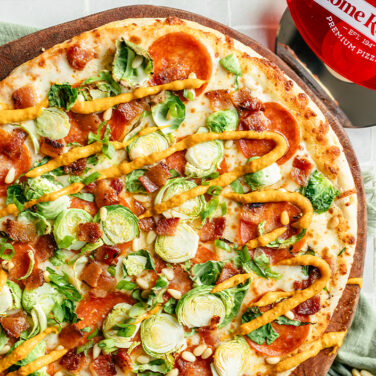 Baked pepperoni pizza topped with brussels, bacon, and more
