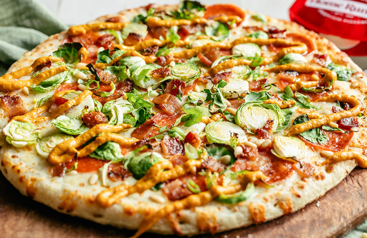 Baked pepperoni pizza topped with brussels, bacon, and more