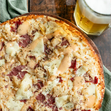 Baked pizza topped with reuben sandwich ingredients