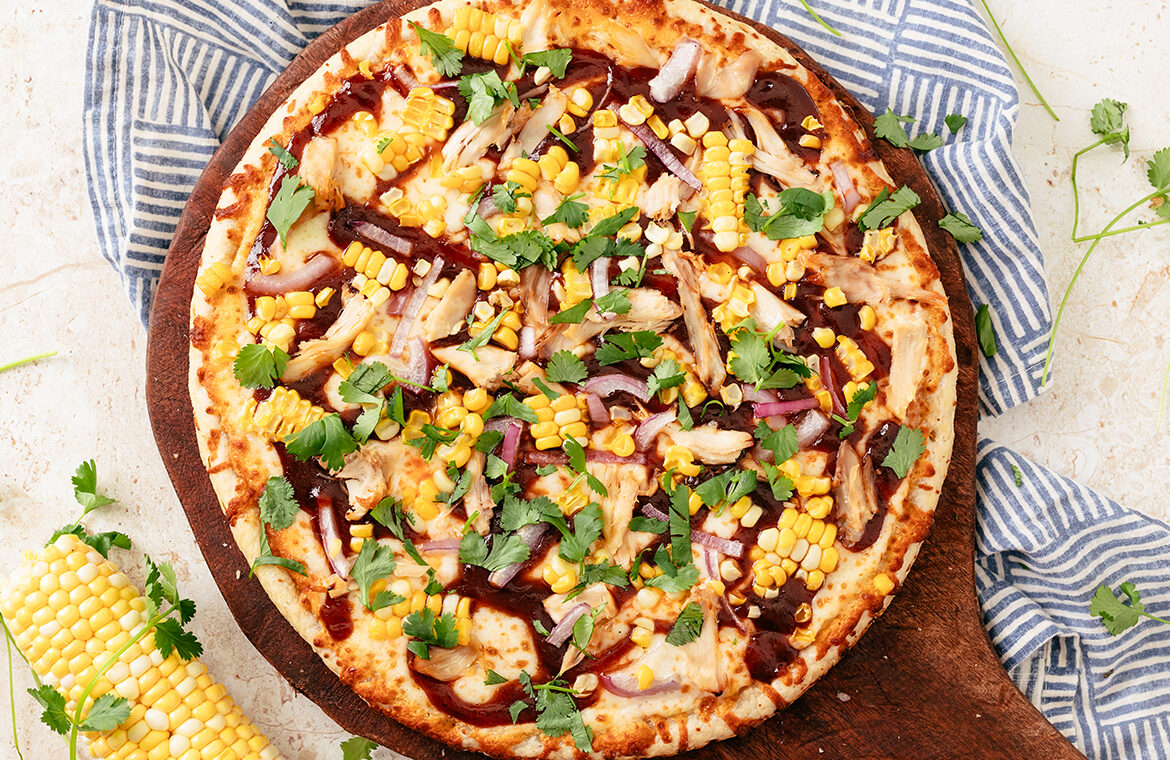 Baked pizza topped with corn and other ingredients from the recipe