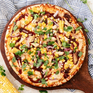 Baked pizza topped with corn and other ingredients from the recipe
