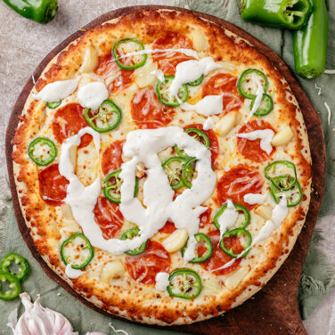 Baked pizza with recipe ingredients on top