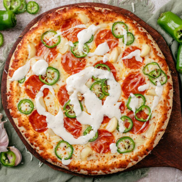 Baked pizza with recipe ingredients on top
