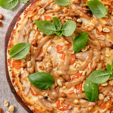 Baked pizza with recipe ingredients on top