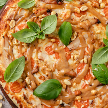 Baked pizza with recipe ingredients on top