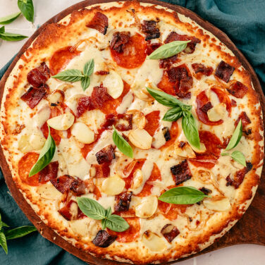 Baked Home Run Inn Pizza with recipe ingredients on top