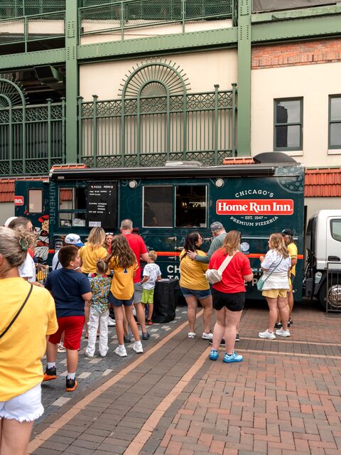 Home Run Inn Food Truck serving food to a crowd in Gallagher Way