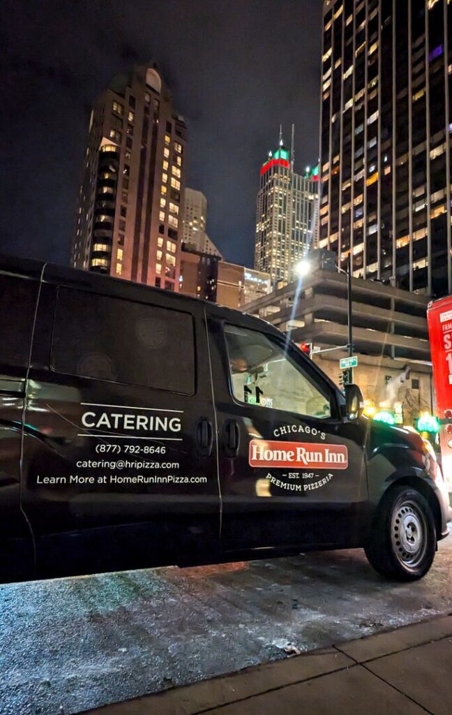 Catering delivery vehicle in Chicago at night