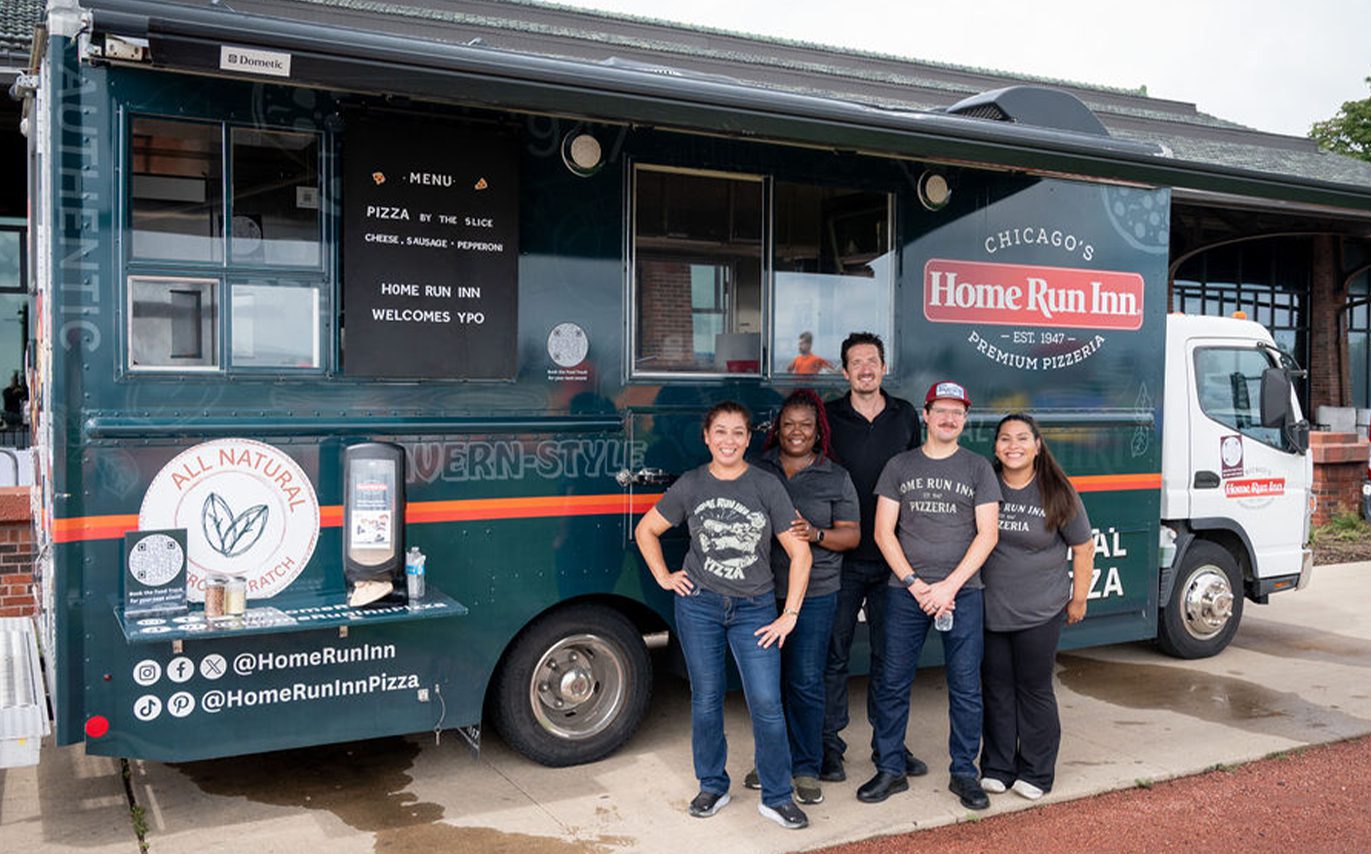 Food truck with HRI teammates posing in front, smiling