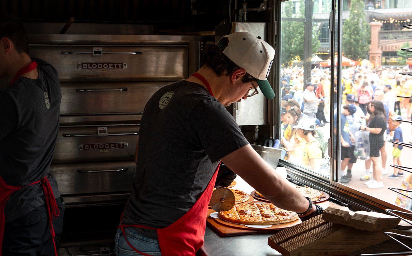 HRI teammate cutting pizza in the food truck