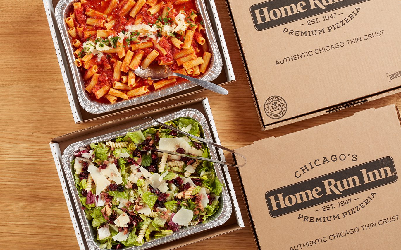 Pasta and salad boxed in catering packages, top down view