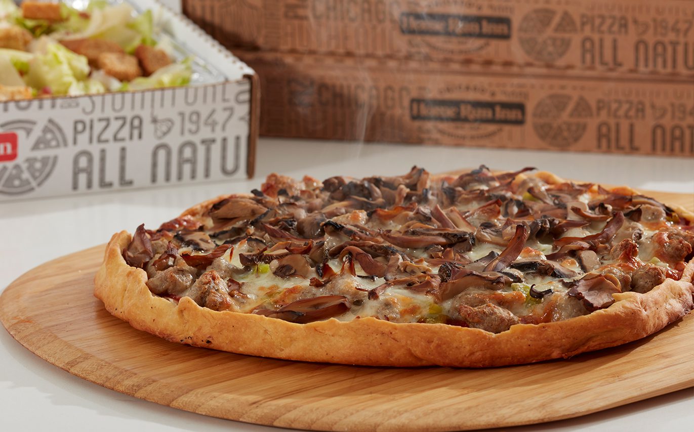 Steaming pizza topped with mushrooms